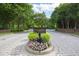 Landscaped entrance to The Gardens on Glenwood with a decorative sign and lush greenery at 2813 Market Bridge Ln # 104, Raleigh, NC 27608