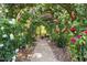 Charming rose garden path leading to a bench, enveloped in climbing roses at 2813 Market Bridge Ln # 104, Raleigh, NC 27608
