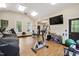 Bright gym featuring cardio equipment, ample lighting, and a wall-mounted television at 2813 Market Bridge Ln # 104, Raleigh, NC 27608