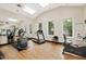 Well-lit gym with mirrors, cardio machines, and multiple windows for natural light at 2813 Market Bridge Ln # 104, Raleigh, NC 27608