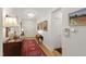 Hallway featuring hardwood floors, decorative wallpaper, elegant lighting, and framed artwork at 2813 Market Bridge Ln # 104, Raleigh, NC 27608