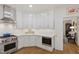 Well-equipped kitchen with stainless steel appliances, white cabinetry and hardwood floors at 2813 Market Bridge Ln # 104, Raleigh, NC 27608