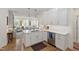 Open kitchen with white cabinets, stainless steel appliances, and hardwood floors at 2813 Market Bridge Ln # 104, Raleigh, NC 27608