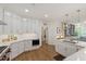 Spacious kitchen with white cabinets, stainless appliances, and hardwood flooring at 2813 Market Bridge Ln # 104, Raleigh, NC 27608