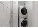 Convenient laundry room features stacked washer and dryer, and ample storage cabinetry at 2813 Market Bridge Ln # 104, Raleigh, NC 27608