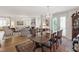 Open-concept living room with a seamless flow to the dining area and balcony, perfect for entertaining at 2813 Market Bridge Ln # 104, Raleigh, NC 27608
