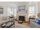 Cozy living room features a decorative fireplace, plantation shutters, and comfortable furniture at 2813 Market Bridge Ln # 104, Raleigh, NC 27608