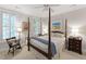 Bright main bedroom with four poster bed, plantation shutters, and classic decor at 2813 Market Bridge Ln # 104, Raleigh, NC 27608