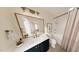 Bathroom features a framed mirror, white countertop, black cabinet and patterned shower curtain at 2940 C Chapel Hill Road, Durham, NC 27707