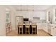 Bright kitchen features white cabinets, stainless steel appliances and a kitchen island with bar stool seating at 2940 C Chapel Hill Road, Durham, NC 27707