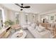 Sunlit living room features neutral walls, bright furniture, large windows, and seamlessly connects to kitchen at 2940 C Chapel Hill Road, Durham, NC 27707