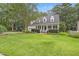 Charming two-story home with a manicured lawn, mature trees, and a welcoming front porch at 314 Chanticlair Dr, Apex, NC 27502