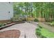 Spacious backyard patio with brick pavers and beautifully landscaped garden beds at 314 Chanticlair Dr, Apex, NC 27502