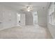 Spacious bedroom featuring neutral carpet, window, and doorway to the laundry room at 314 Chanticlair Dr, Apex, NC 27502