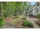 Serene backyard with a patio, lush lawn, mature trees, and garden at 314 Chanticlair Dr, Apex, NC 27502