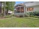 Backyard with a screened-in porch, garden, and mature trees at 314 Chanticlair Dr, Apex, NC 27502