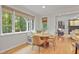 Bright breakfast nook offers banquette seating, views to backyard and access to living area at 314 Chanticlair Dr, Apex, NC 27502