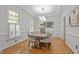 Dining room featuring stylish furnishings, hardwood floors, modern chandelier, and trim at 314 Chanticlair Dr, Apex, NC 27502