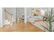 Inviting foyer with hardwood floors, staircase, and views into the living spaces at 314 Chanticlair Dr, Apex, NC 27502