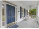 Inviting front porch featuring a blue door, white columns, and comfortable seating at 314 Chanticlair Dr, Apex, NC 27502
