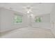 Bedroom featuring neutral carpet, two windows, and a ceiling fan at 314 Chanticlair Dr, Apex, NC 27502