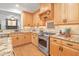 Updated kitchen boasts granite countertops, stainless appliances, and custom cabinets at 314 Chanticlair Dr, Apex, NC 27502
