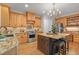 Gourmet kitchen with a central island, stainless steel appliances, and custom cabinetry at 314 Chanticlair Dr, Apex, NC 27502
