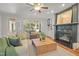 Bright living room with fireplace and built-ins showcases a view to the outdoor living area at 314 Chanticlair Dr, Apex, NC 27502