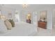 Bright main bedroom with a king bed, neutral decor, carpet, and a view of backyard trees at 314 Chanticlair Dr, Apex, NC 27502