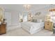 Spacious main bedroom with neutral decor, plush carpet, and a king bed with a tufted headboard at 314 Chanticlair Dr, Apex, NC 27502