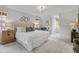 Serene main bedroom featuring neutral tones, carpet, and a tufted headboard on the king bed at 314 Chanticlair Dr, Apex, NC 27502