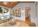 Comfortable screened porch with wicker furniture, wood ceiling, and a view into the home's interior at 314 Chanticlair Dr, Apex, NC 27502