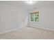 Bright bedroom features neutral carpet, double door closet, and natural light from a window at 314 Chanticlair Dr, Apex, NC 27502