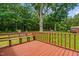 Large deck featuring bench seating, with view to tree-filled backyard at 3315 Mebane Oaks Rd, Mebane, NC 27302