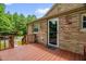 Deck featuring brick exterior with door to inside and stairs at 3315 Mebane Oaks Rd, Mebane, NC 27302