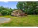 Brick home featuring a small wooden deck with well maintained lawn at 3315 Mebane Oaks Rd, Mebane, NC 27302