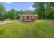 Brick home featuring a small wooden deck with well maintained lawn at 3315 Mebane Oaks Rd, Mebane, NC 27302