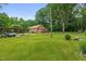 A well-maintained lawn and a covered parking area add to the appeal of the brick home's exterior at 3315 Mebane Oaks Rd, Mebane, NC 27302
