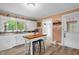 Charming kitchen with white cabinets and an island with seating at 3315 Mebane Oaks Rd, Mebane, NC 27302