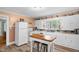 Bright and efficient kitchen with white cabinets and a central island at 3315 Mebane Oaks Rd, Mebane, NC 27302