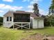 Backyard featuring a screened deck and an enclosed storage area at 3509 Neptune Dr, Raleigh, NC 27604