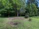Lush backyard with mature trees and landscaping, offering privacy and a natural setting at 3509 Neptune Dr, Raleigh, NC 27604