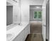 Bright bathroom with double sinks, a large mirror, and access to the bedroom at 3509 Neptune Dr, Raleigh, NC 27604