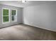 Well-lit bedroom with plush carpet, natural light, and serene views of the outdoors at 3509 Neptune Dr, Raleigh, NC 27604