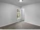 Standard bedroom with neutral carpet, a bright window, and direct access to the hallway at 3509 Neptune Dr, Raleigh, NC 27604