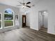 Sunlit living room with hardwood floors, large windows, and a welcoming entrance at 3509 Neptune Dr, Raleigh, NC 27604