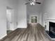 Spacious living room with hardwood floors and a fireplace offers a seamless transition to the outdoor patio at 3509 Neptune Dr, Raleigh, NC 27604
