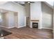 Open-concept living room with a modern fireplace, high ceilings, and wood-look floors at 355 Shaw Rd, Cameron, NC 28326