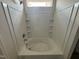 Bathroom with a nice bathtub and shower with tiled enclosure and built-in shelving at 40 Commons Cir, Clayton, NC 27520