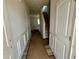 Inviting entryway with white wainscoting, decorative doors, and a staircase leading to the upper level at 40 Commons Cir, Clayton, NC 27520